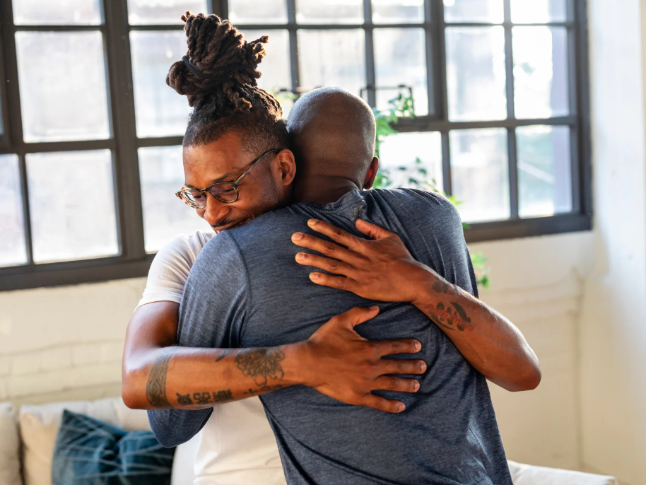 2 men hugging each other